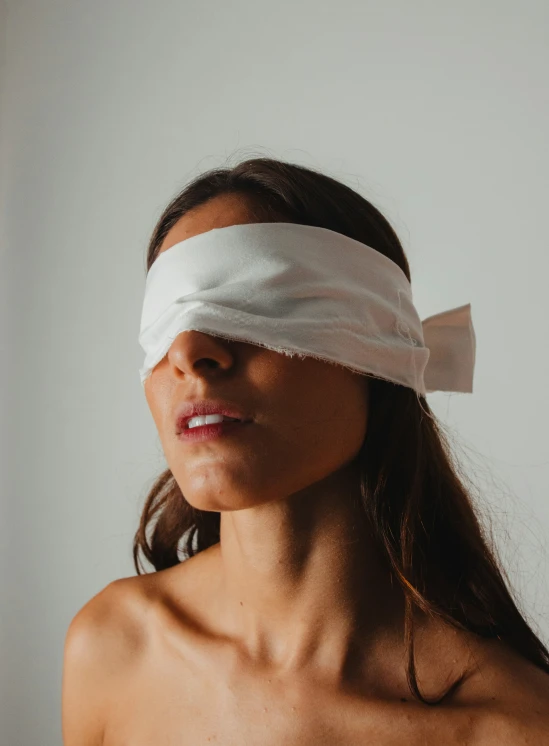 a woman with a band on her head and a bandage over her eye