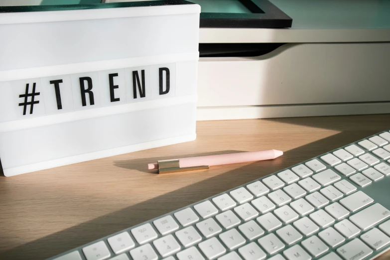 keyboard, pen and light up brick sitting on a desk