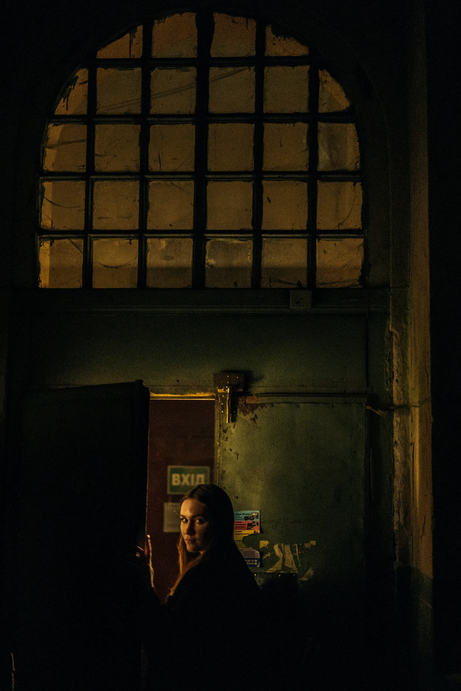 a man in the dark and drinking a beverage