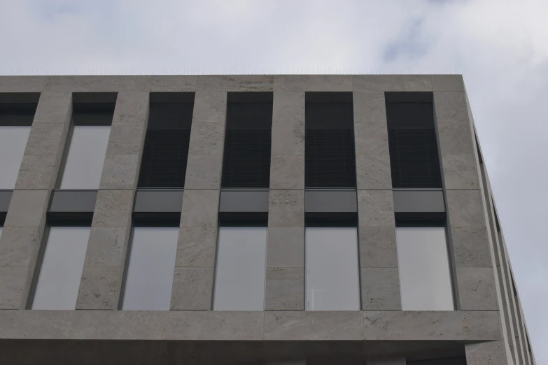 a tall gray building with some windows on the side of it