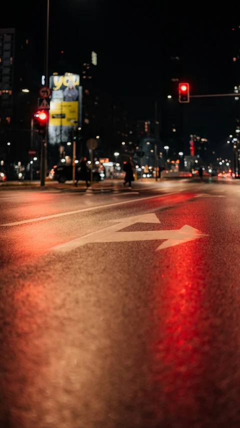 city street at night with lights and a cross walk