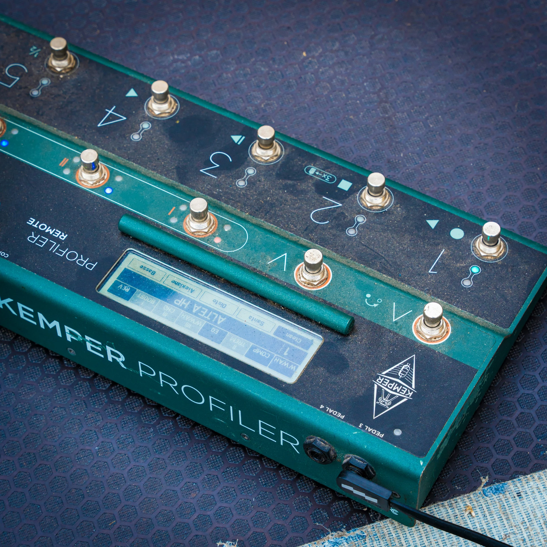 a green electronic device on top of a blue surface