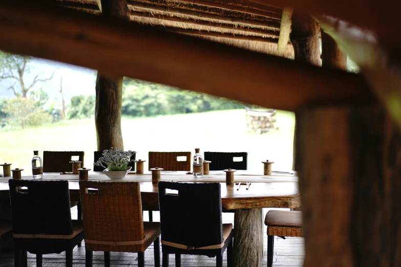 table set outside with chairs and trees in the distance