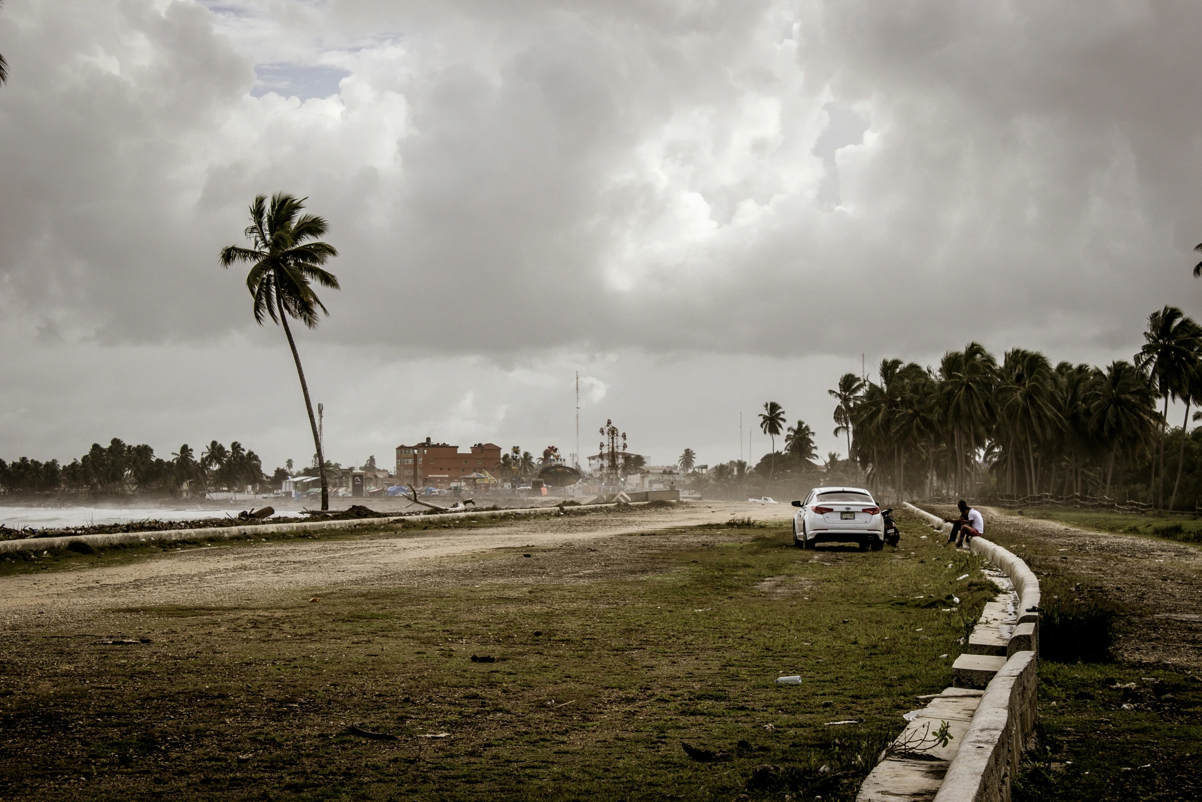 cars traveling on the road beside an island