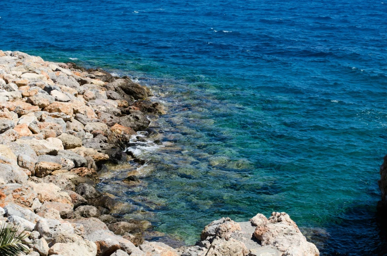 an island with some rocks that look like they are submerged in the water