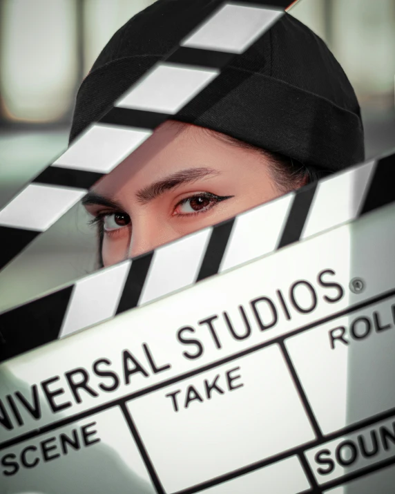 a person holding a large white clapboard