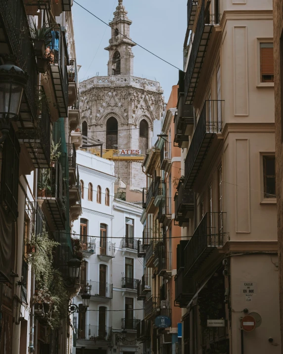 a street with buildings and an old clock tower in the background