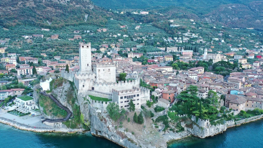 an island in the middle of water with buildings and a clock tower on it