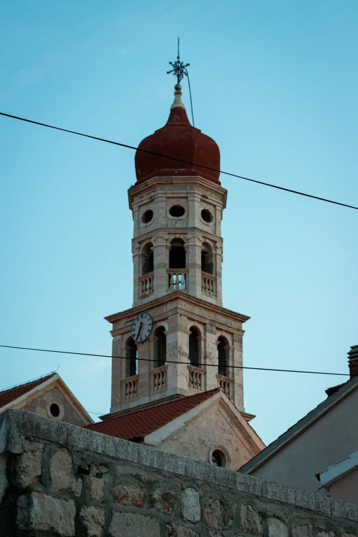 a large bell tower towering over two buildings