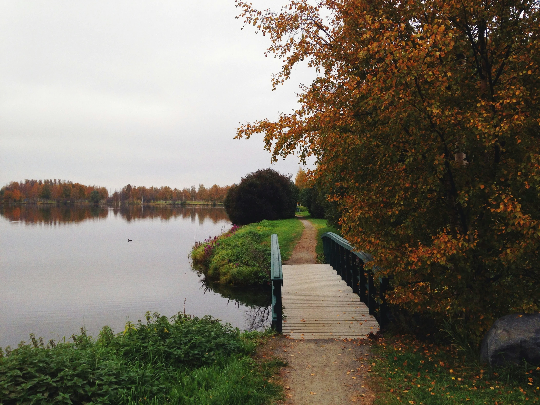 a view of an outside walkway, overlooking water