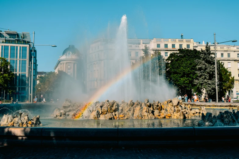 this fountain has a rainbow coming out of it