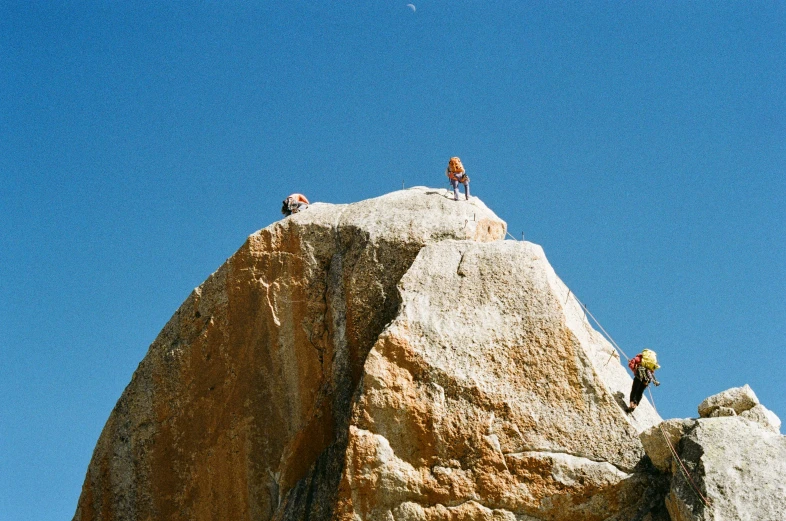 people standing on top of a rock formation