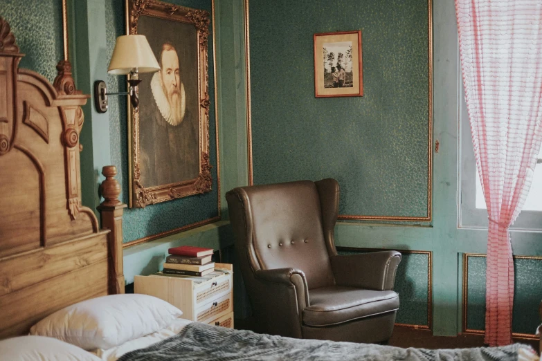 a chair sitting next to an ornately decorated bed