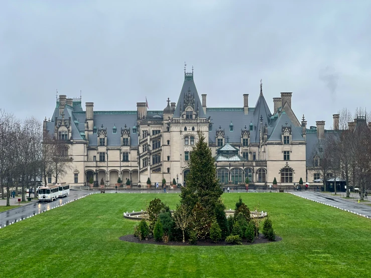 an exterior view of a large building with trees and shrubs