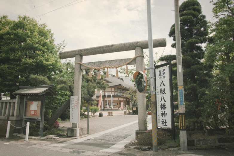 a small japanese town has tall trees with asian writing