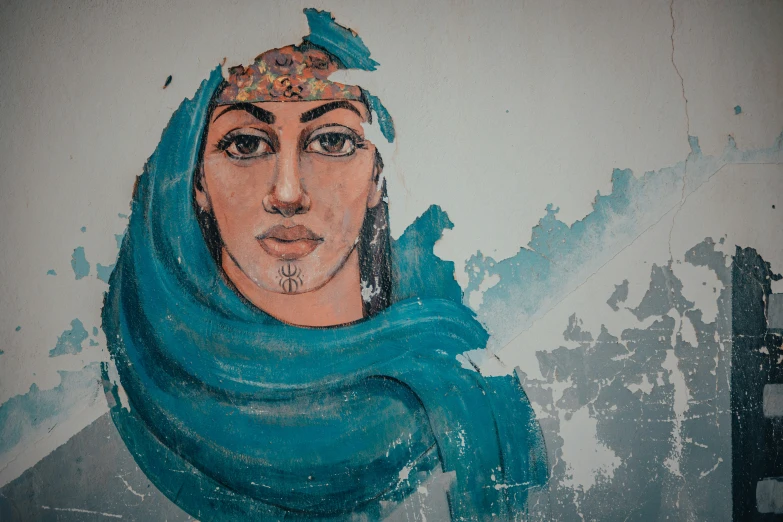 painting on the wall of a woman wearing a headscarf