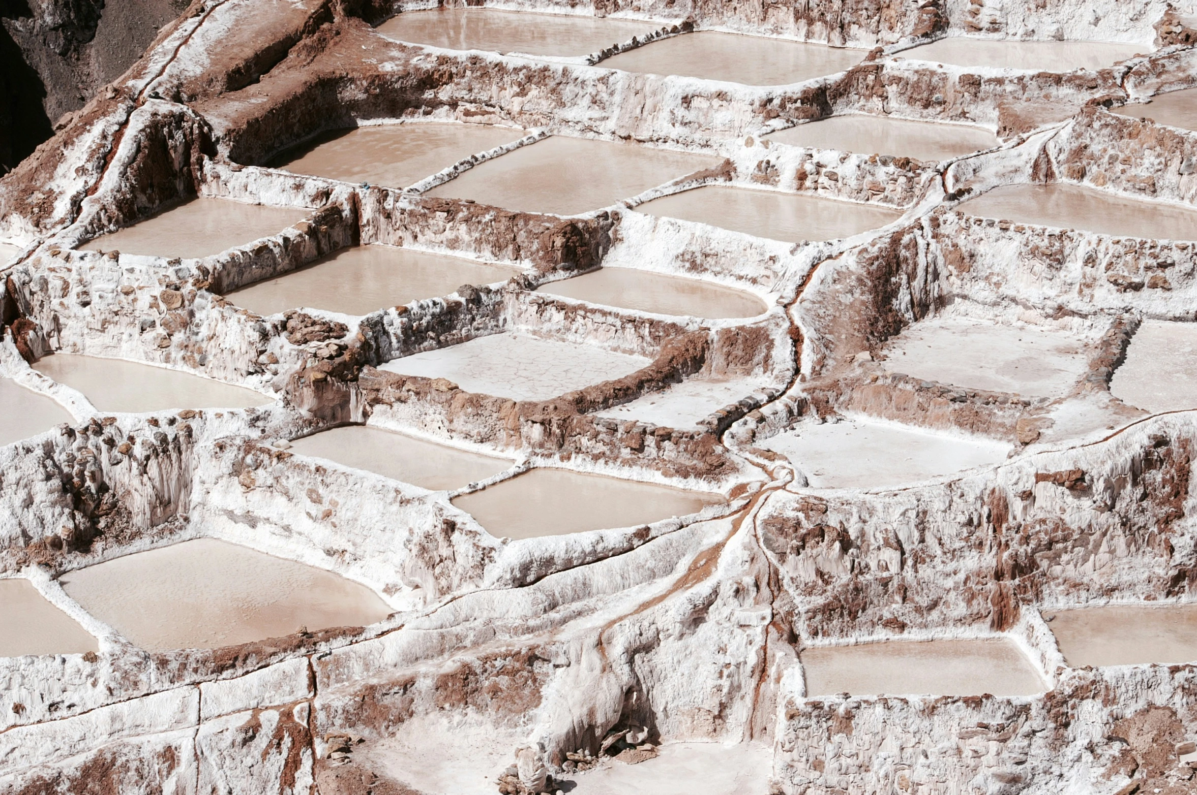 salt terraces at the bottom of a mountain