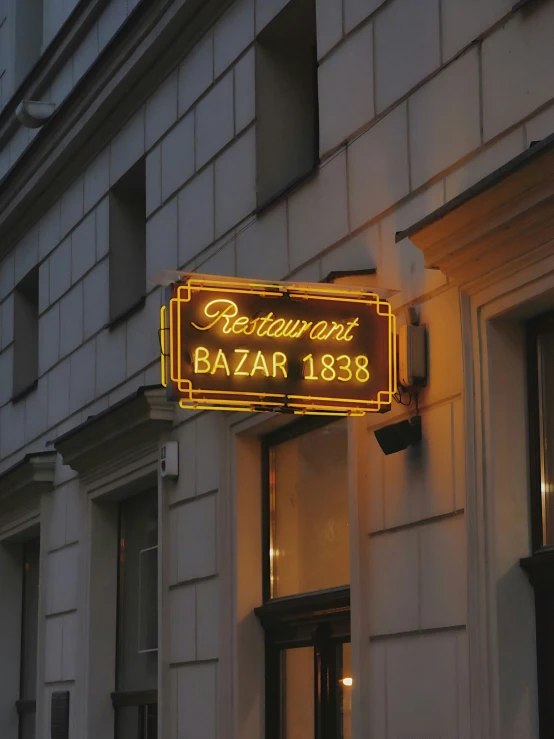 a neon sign reading the restaurant bazaar