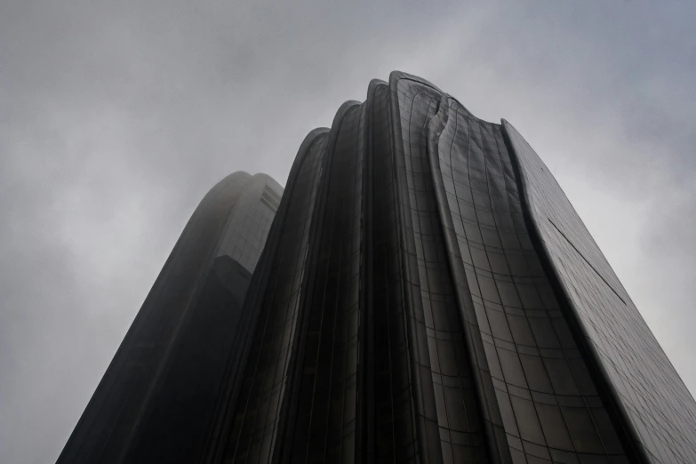 tall buildings with a very cloudy sky behind them