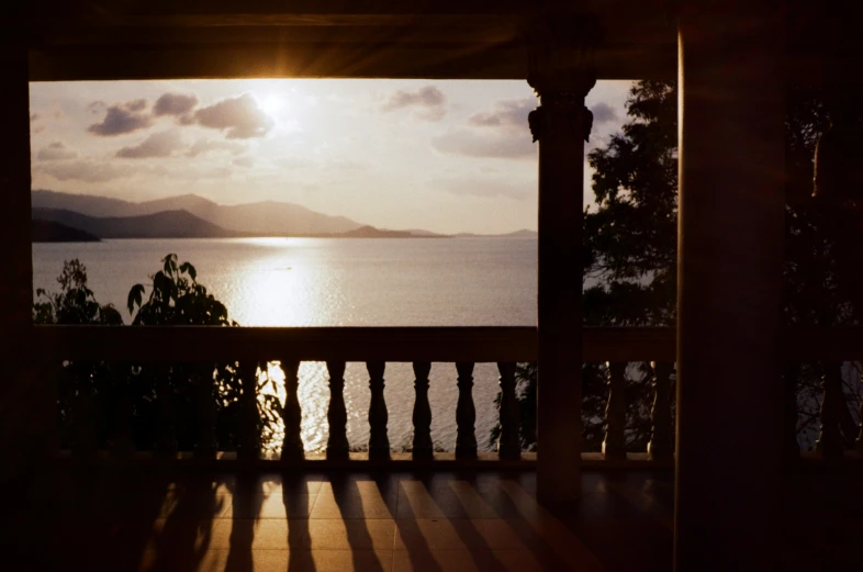 the view from inside a house shows the sky and water