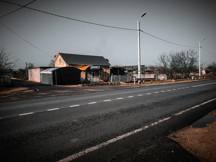 several small houses and a street lined with utility poles