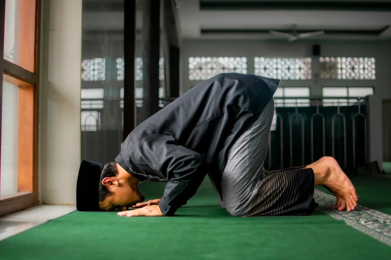 the person is standing up while doing a handstand