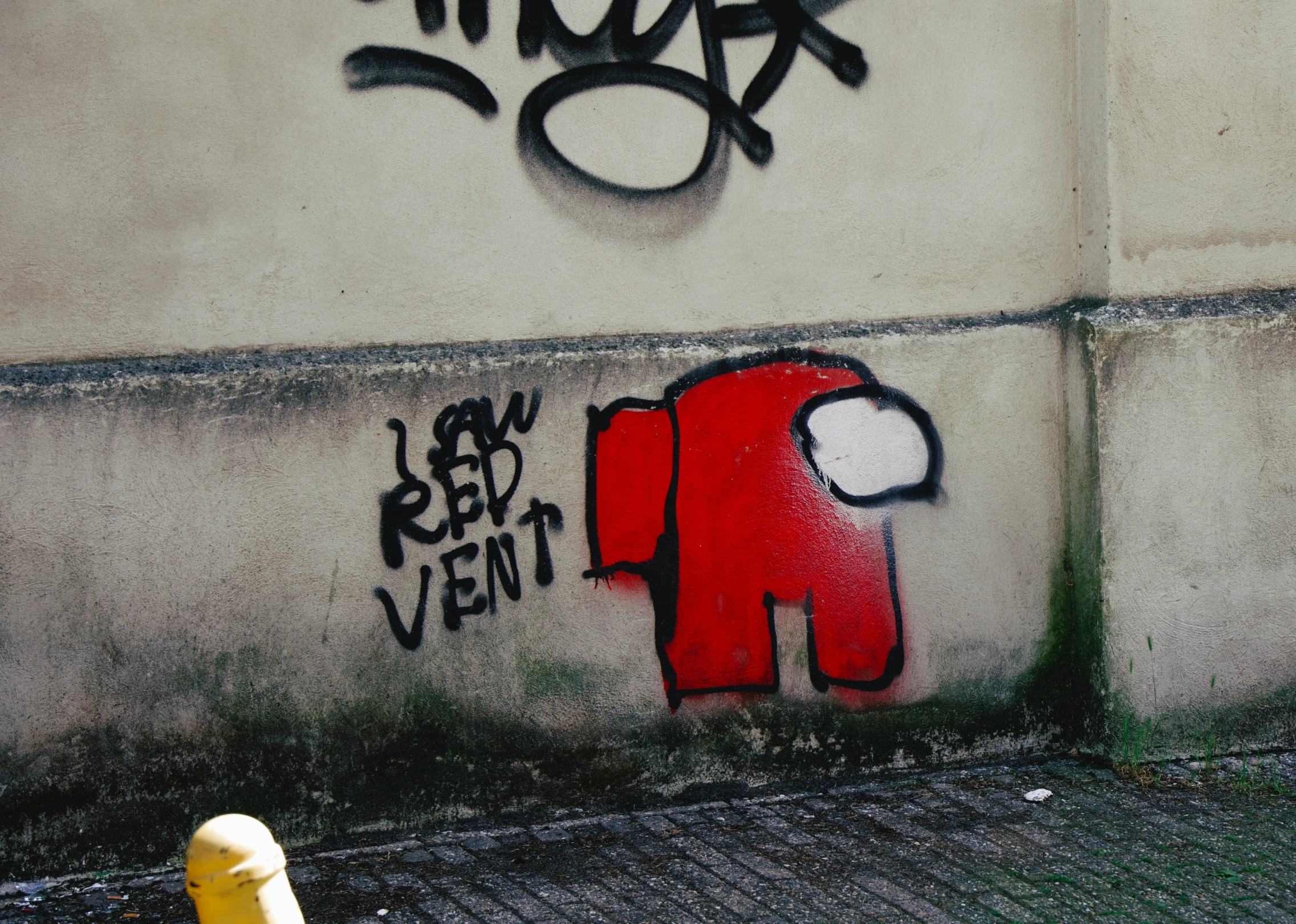 a wall with graffiti and an old man