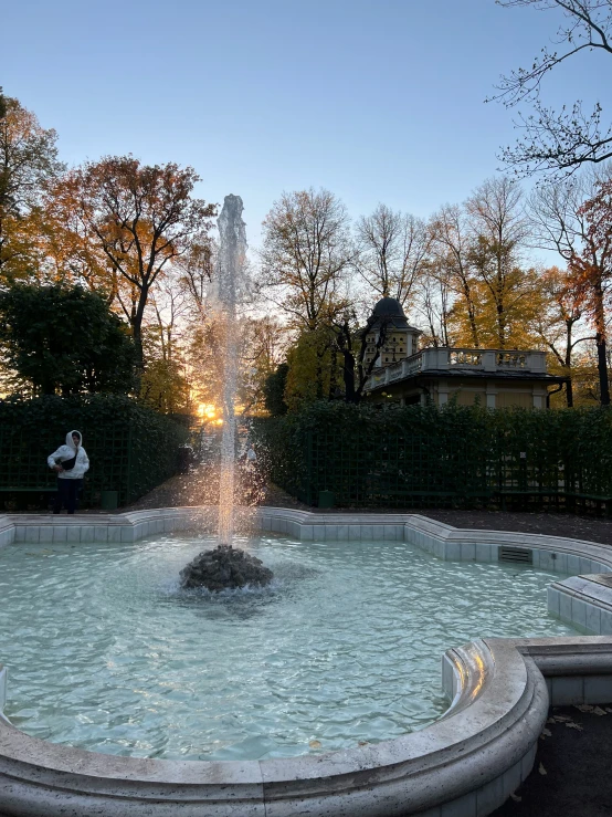 a fountain sitting in the middle of a park