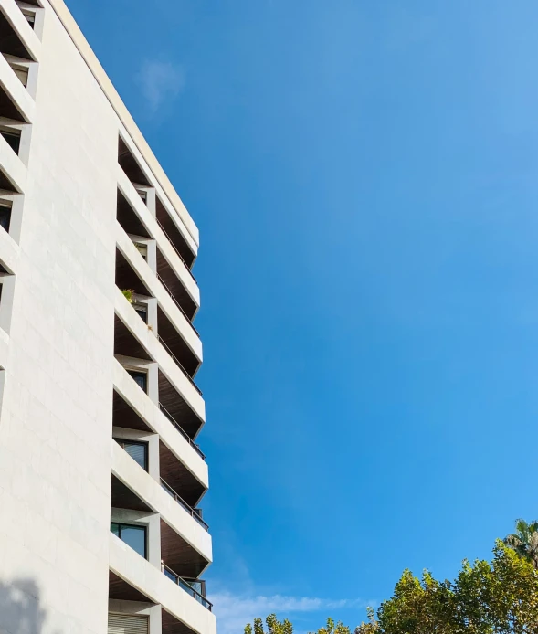 a white bird flying over a building