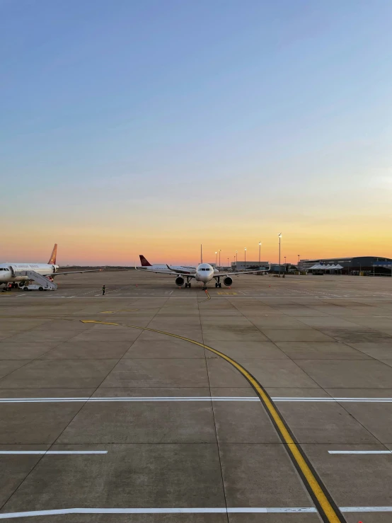 the view from inside the airplane of two planes at the airport