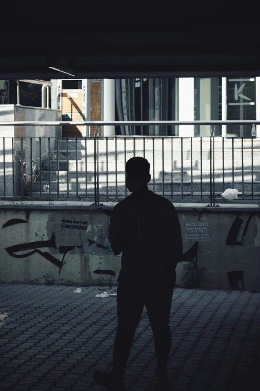 a person walking down the sidewalk past a building