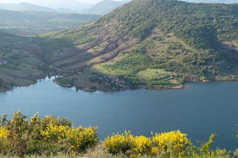 a couple of large water reservoirs in the middle of a lush green hillside