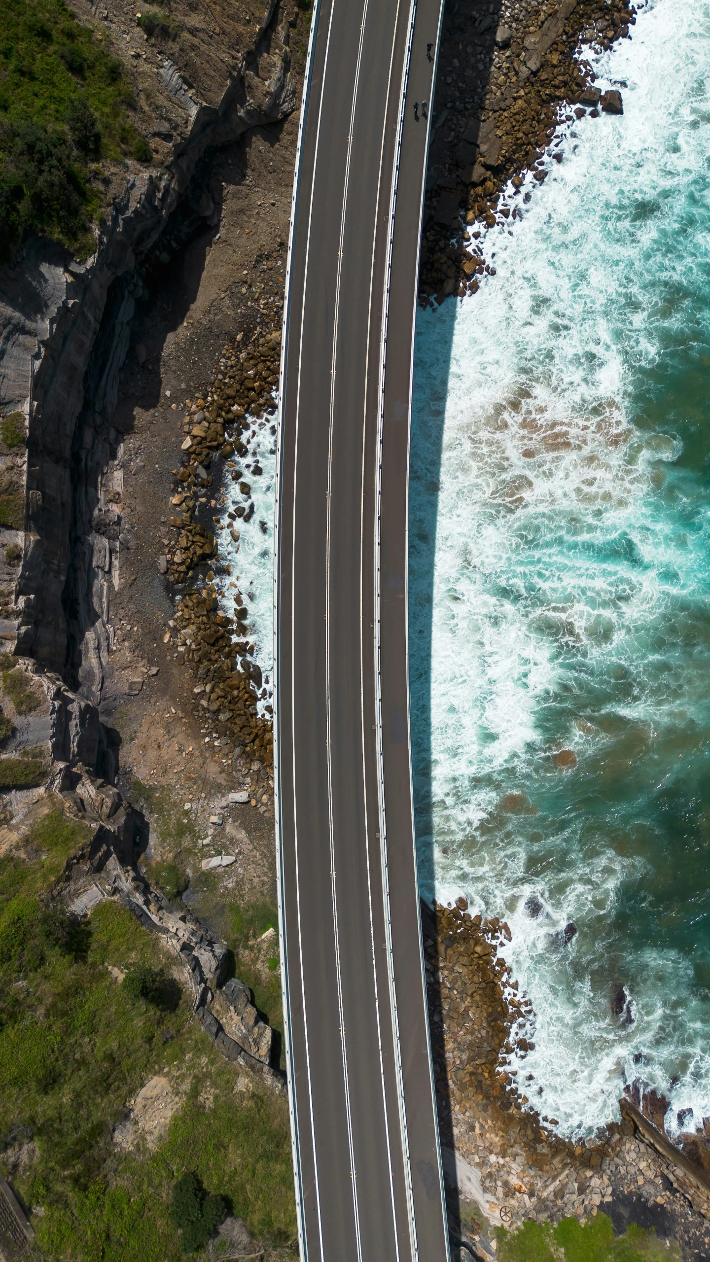 a highway that has been cut through the ground and over some water