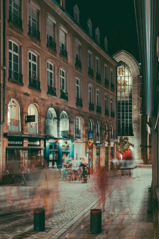 blurry image of street with people on sidewalks at night