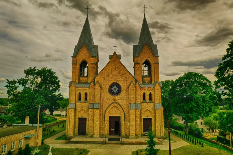 a yellow church with two clocks on it's sides