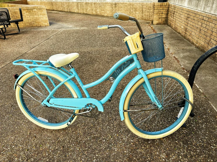 a light blue bike is sitting in a basket