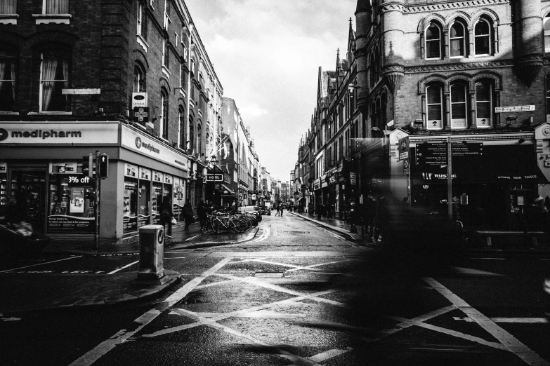 a city street lined with buildings with a dark sky in the background