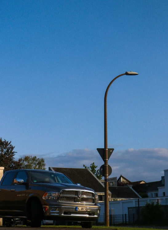 an old - style van parked at an intersection near a street lamp