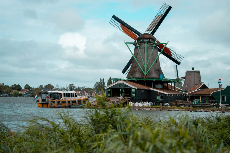 the view of a windmill in the water from a boat