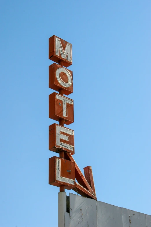 motel sign on top of old brick building
