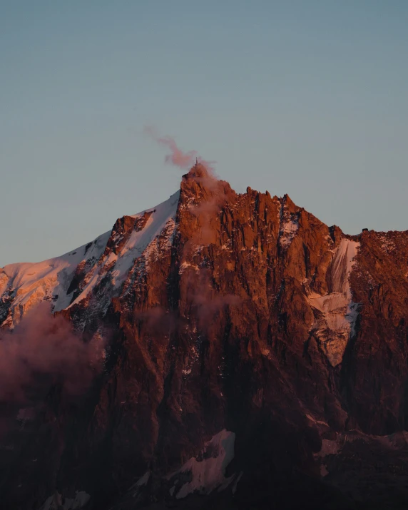 a mountain with a snowy peak near the top