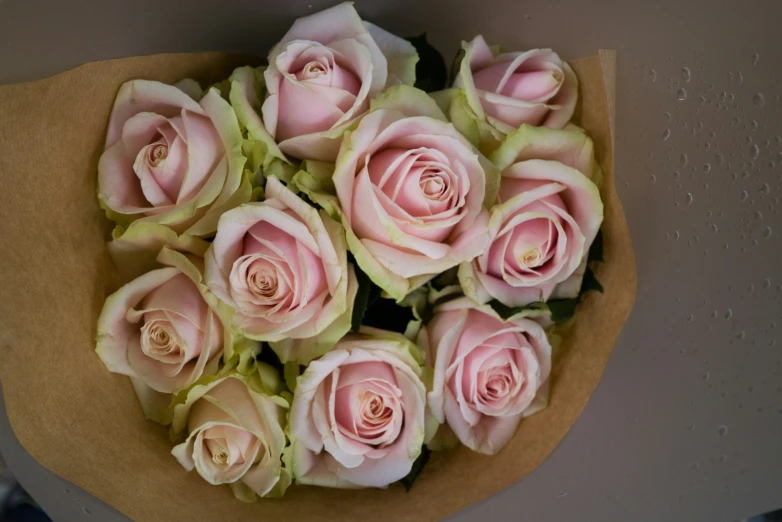 a bouquet of roses is sitting on a table