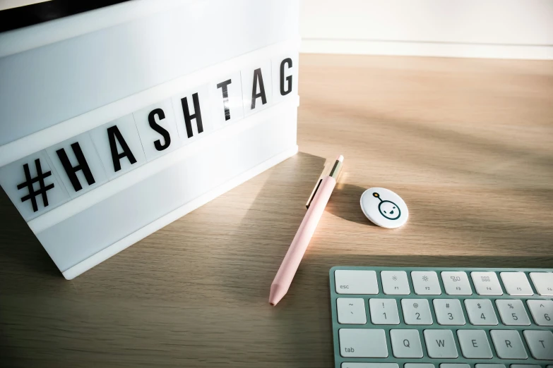 keyboard and a mouse sit next to a hash tag