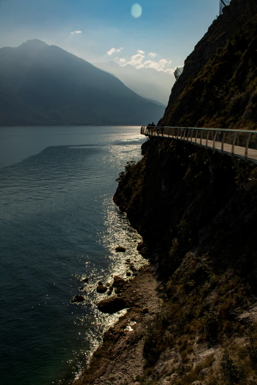 the train is traveling along side of a large body of water