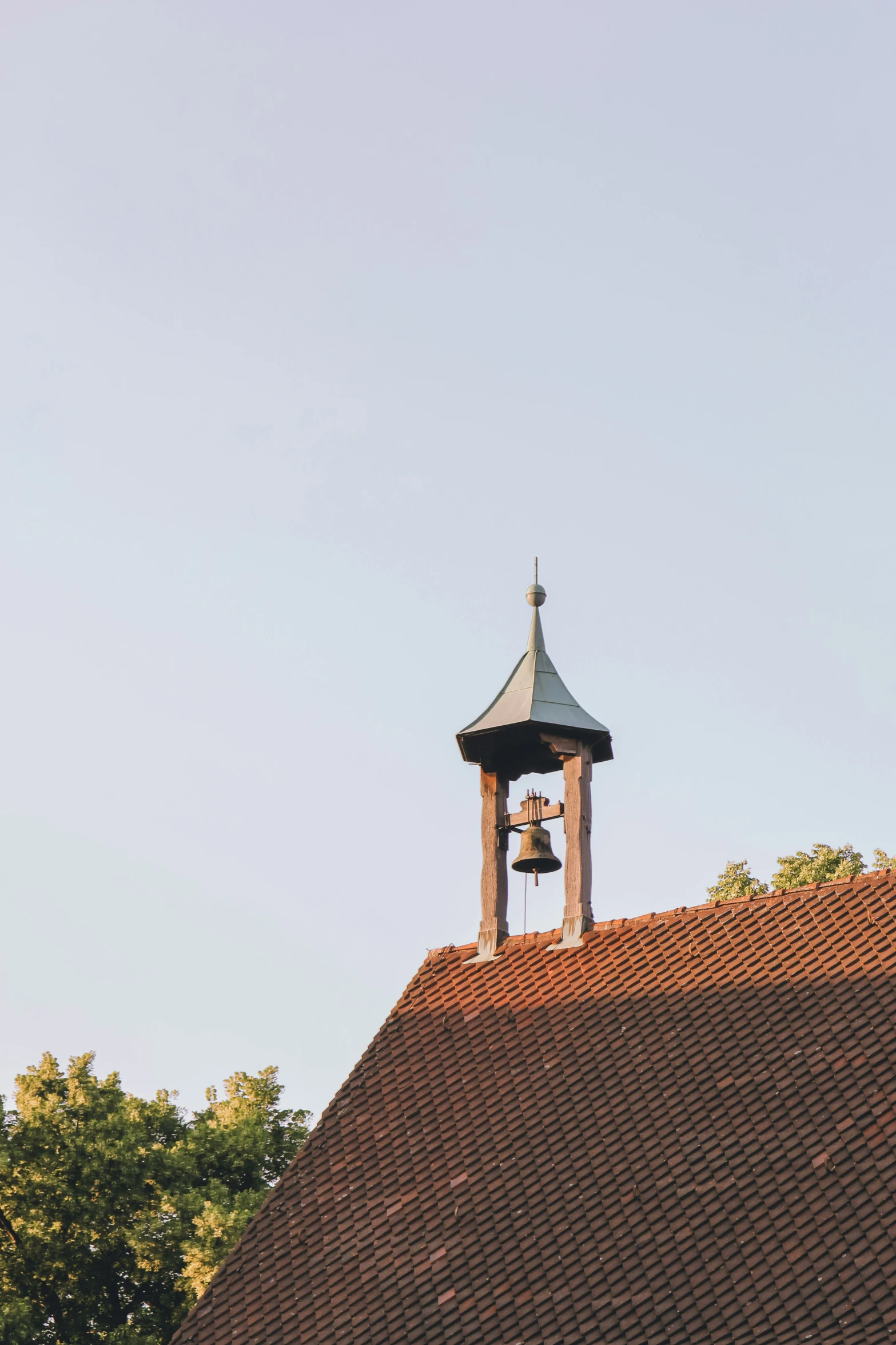 a bell tower with a clock on it in the sky