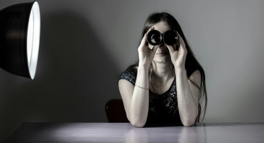 a person sitting at a table with a camera