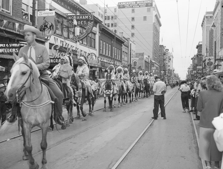 an old black and white po of men on horseback in the parade