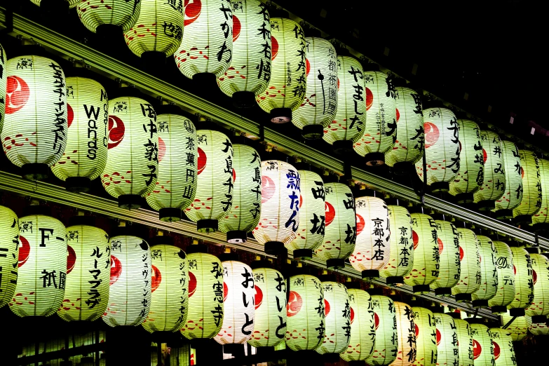 a couple rows of paper lanterns hanging from the ceiling