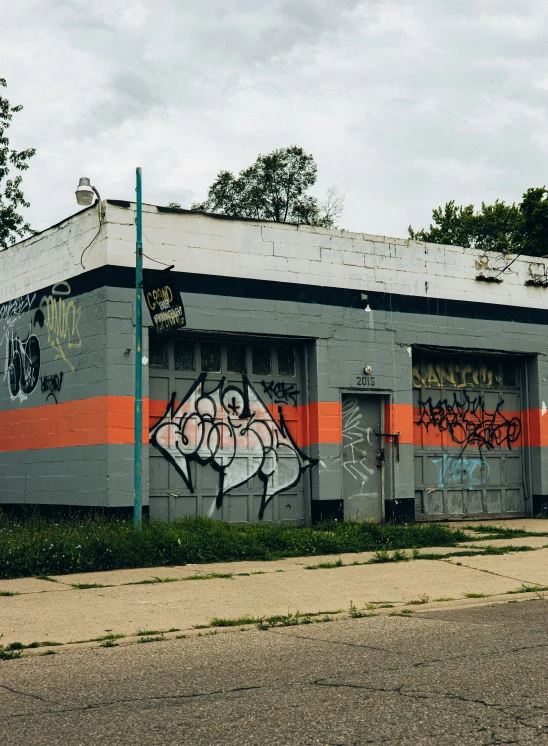 an old building with graffiti on it has two levels