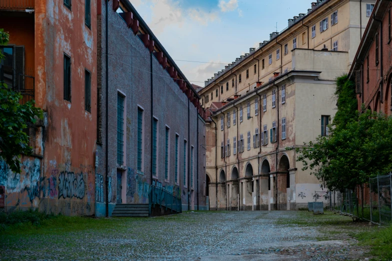 an empty street in front of some buildings with a dirt road